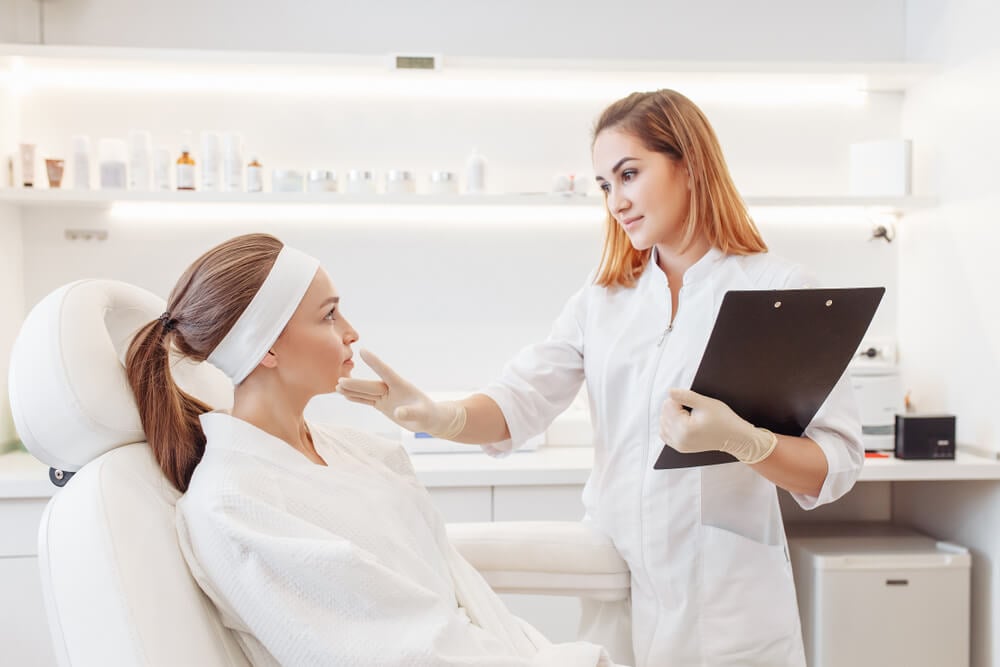 med spa_Young pretty woman came to a beauty salon and consults with a beautician on anti-aging treatments. Self care concept