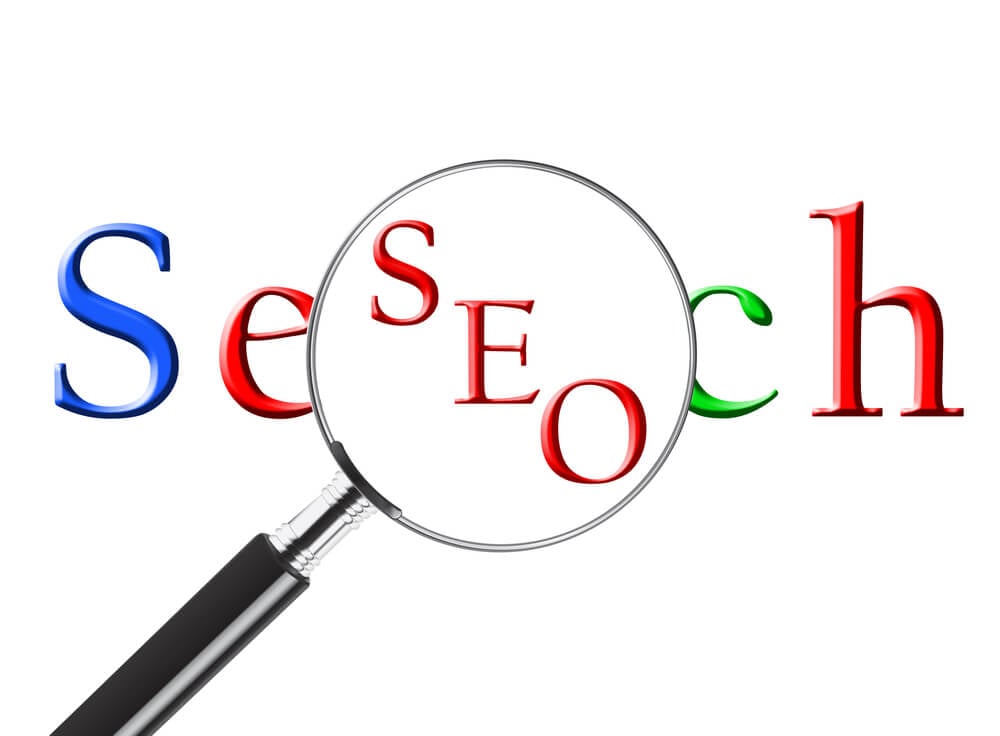 SEO_Magnifying glass over the word Search revealing SEO or Search Engine Optimization