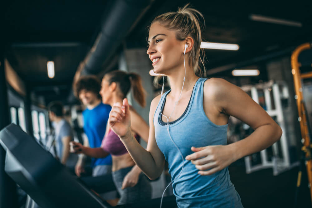 fitness_Young people running on a treadmill in health club.