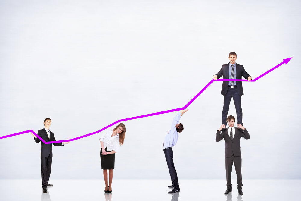 sales_business people pushing a business graph upwards