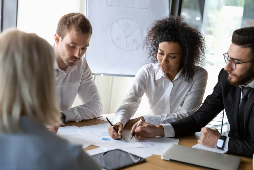 interim CMO_Diverse employees discussing strategy, colleagues sharing startup ideas, business team working on project together, reading documents, analyzing statistics, group negotiations in boardroom