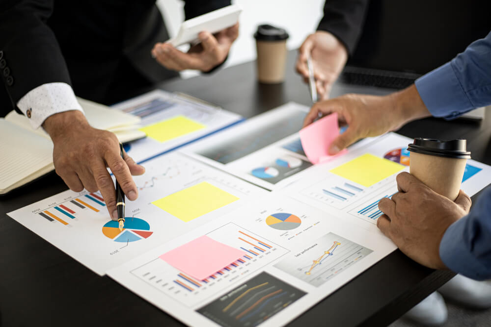 strategies_The atmosphere in the meeting room where the businessmen are meeting, information papers and charts are placed on the table to support the business planning meeting to grow. Business idea.