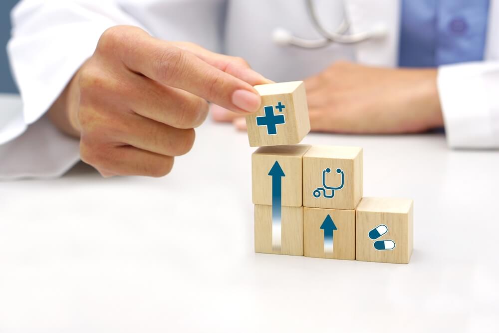 healthcare_Hand holding a wooden block cube with healthcare medical icon symbol. Medical and health concept.
