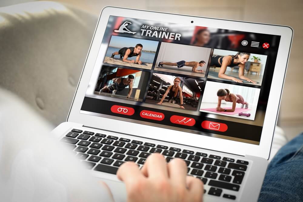 personal trainer_Personal trainer online. Man viewing website via laptop at home, closeup