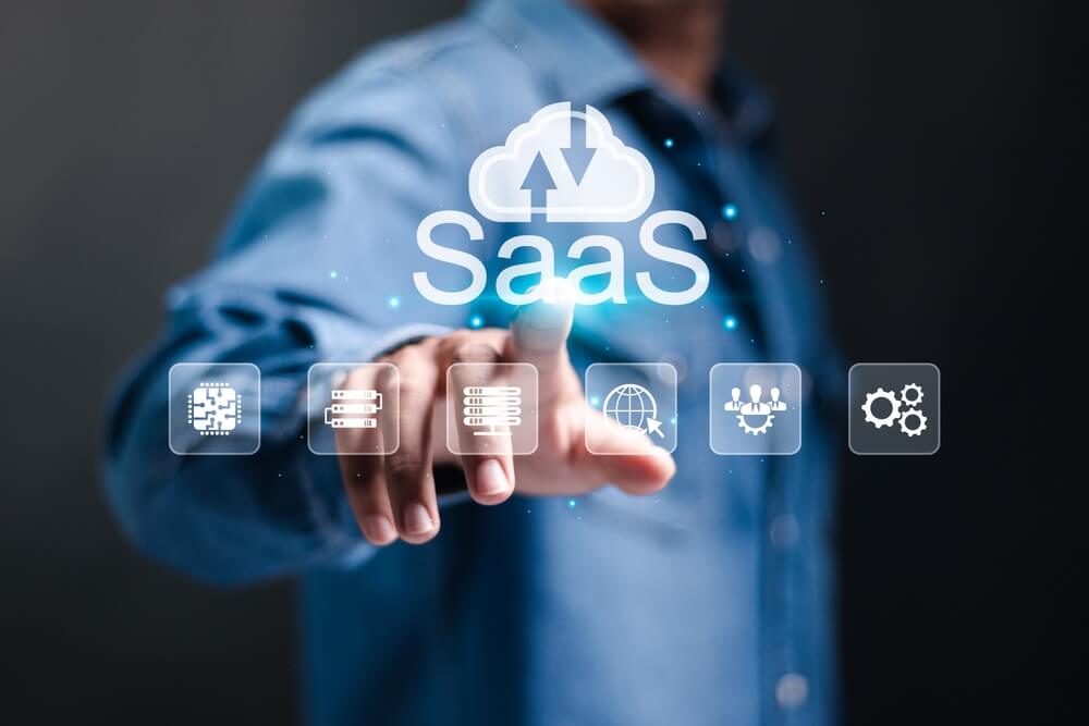 SaaS_SaaS, software as a service concept. Businessman touching cloud SaaS icon on virtual screen. software services on cloud system. Internet and networking technology.