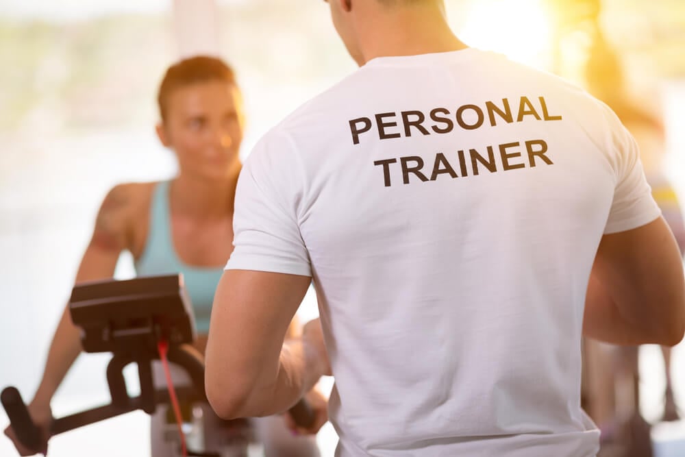 personal trainer_Personal trainer on weights lifting training with client