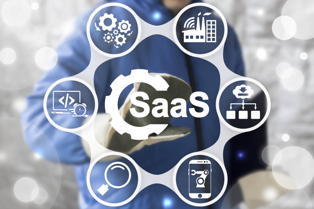 SaaS_SAAS Computing IOT Industry 4.0 Development Concept. Industrial worker touched gear SaaS icon on virtual screen. Software as a service in manufacturing.