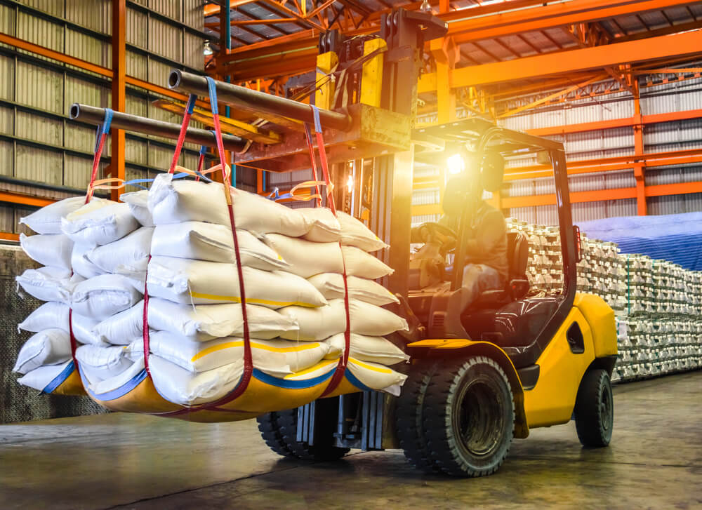 food supplier_Forklift handling sugar bag for stuffing into container for export. Distribution, Logistics Import Export, Warehouse operation, Trading, Shipment, Delivery concept.