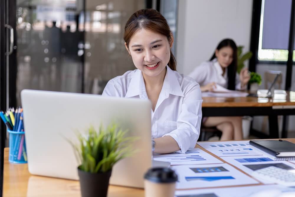 CRO_A businesswoman is checking company financial documents and using a laptop to talk to the chief financial officer through a messaging program. Concept of company financial management.