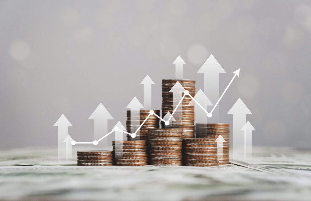 financial growth_stack of silver coins with trading chart in financial concepts and financial investment business stock growth