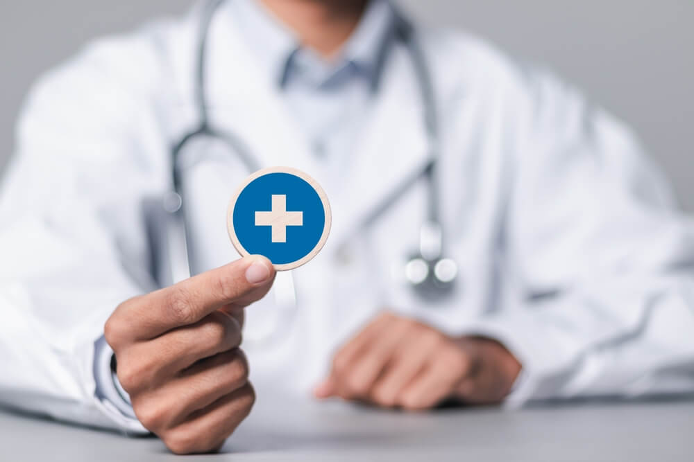 medical seo_Health insurance concept, Doctor holding wooden cubes with medical icons for healthcare and medical. health and access to welfare health.