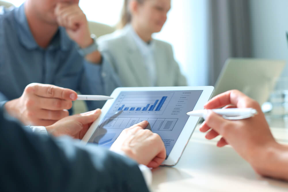 analytics_Business person analyzing financial statistics displayed on the tablet screen