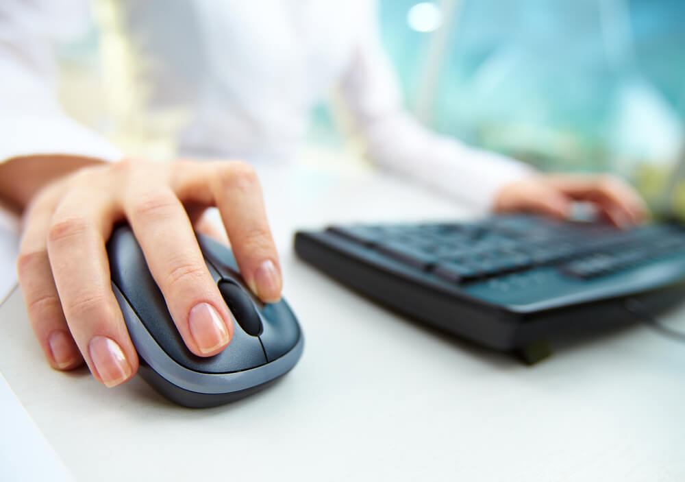 PPC click_Image of female hands clicking computer mouse