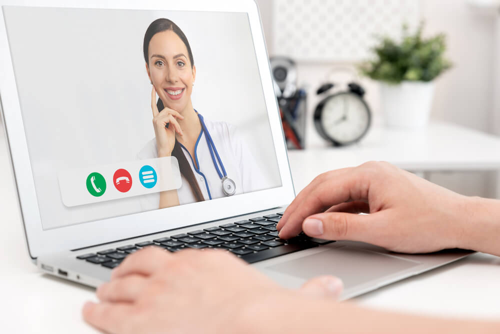 telehealth_Doctor with a stethoscope on the computer laptop screen. Telemedicine or telehealth concept.