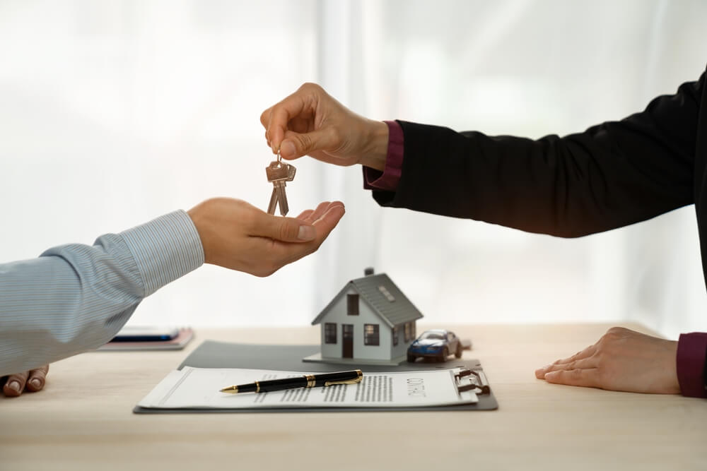 real estate_Businessman, insurance sales agent handing over house and car keys to customer in trading or renting in mutual agreement at security concept office housing investment.