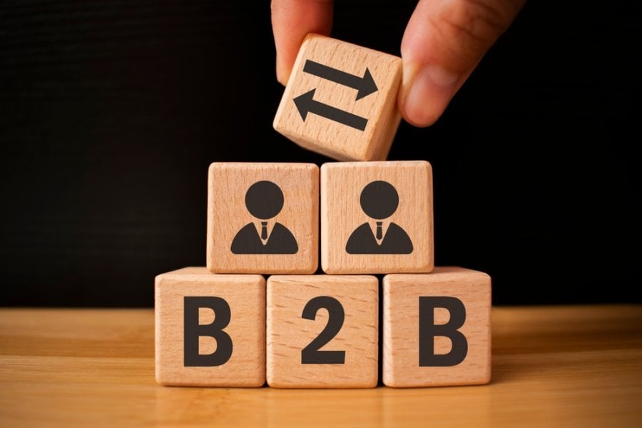 Wooden cubes with with icons the letters B2B. B2B, business to business marketing symbol. Business and B2B concept. Wooden cubes table background.