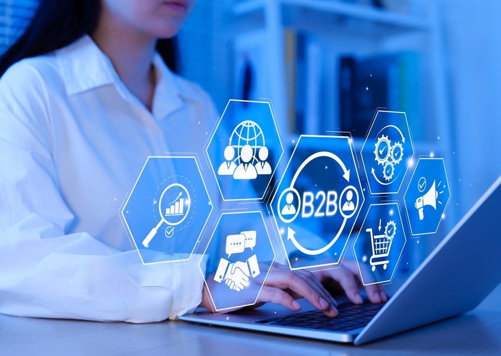 B2B business strategy concept. Business professional working with B2B interface on laptop, conceptualizing strategy, partnership, targets in business to business services. E-commerce, B2B Marketing,