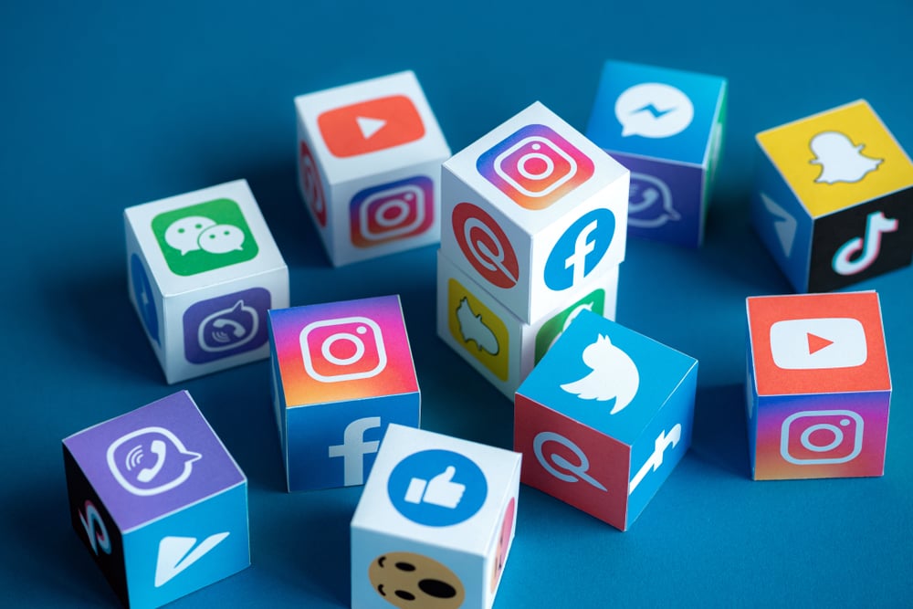 A paper cubes collection with printed logos of world-famous social networks and online messengers, such as Facebook, Instagram, YouTube, Telegram and others