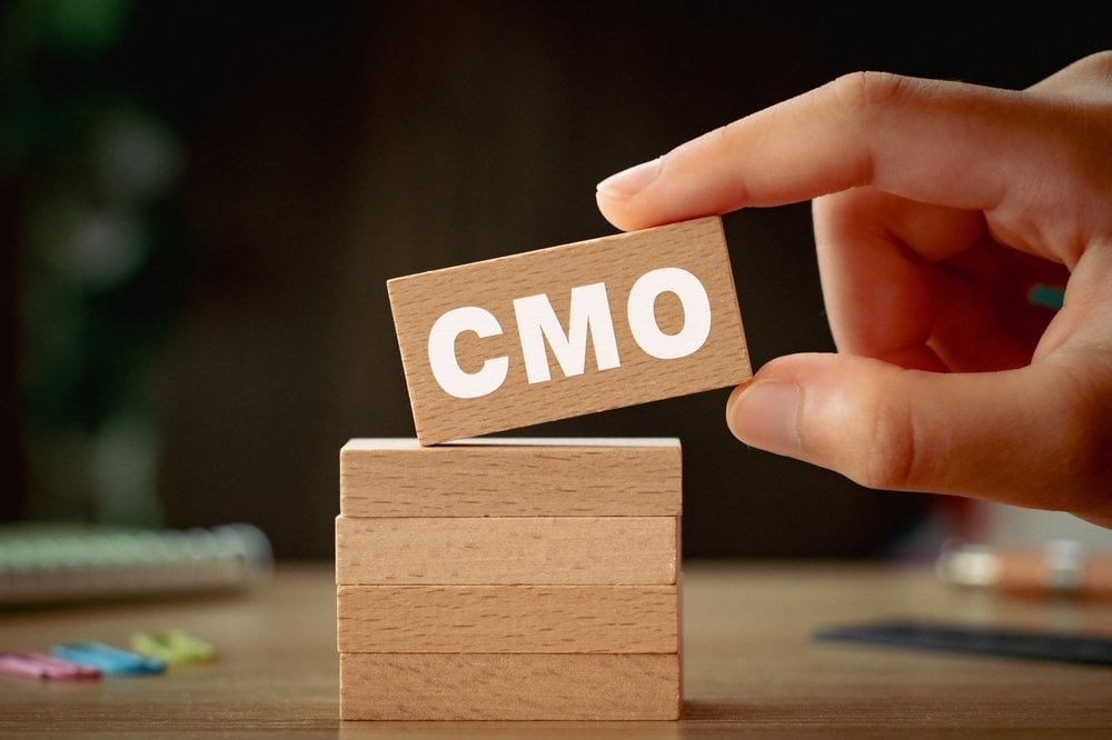 There is notebook with the word CMO. It is an abbreviation for Chief Marketing Officer as eye-catching image.