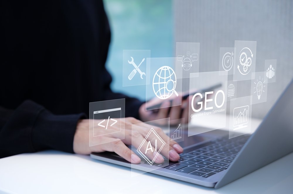 GEO Concept. Generative Engine Optimization for Online Marketing Strategy, Hands typing on laptop with icons representing AI, coding, modern online marketing, and advertising strategies.