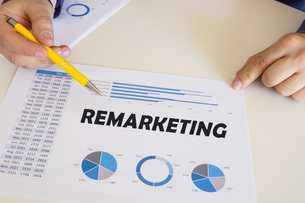 Financial concept about REMARKETING with phrase on the printout with diagrams and tables. 