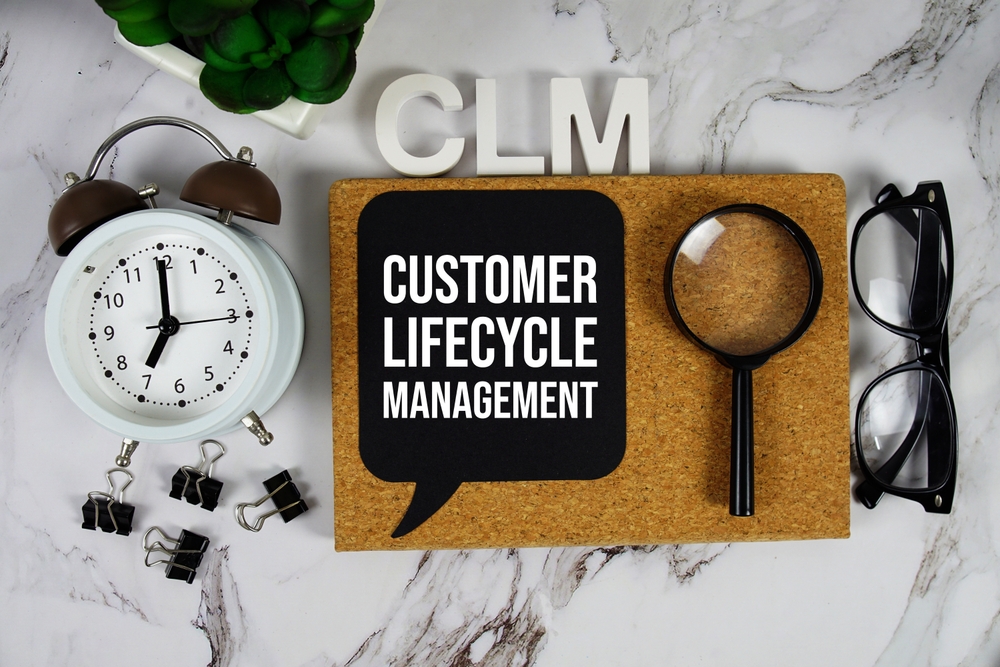 CLM - Customer Lifecycle Management acronym with alarm clock and magnifying glass, business concept background